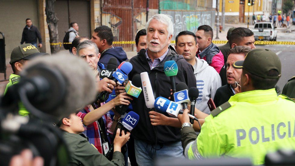 Bogota Mayor Enrique Penalosa (C) talks to the press at the area of an explosion in the La Macarena neighborhood of Bogota, Colombia, 19 February 2017