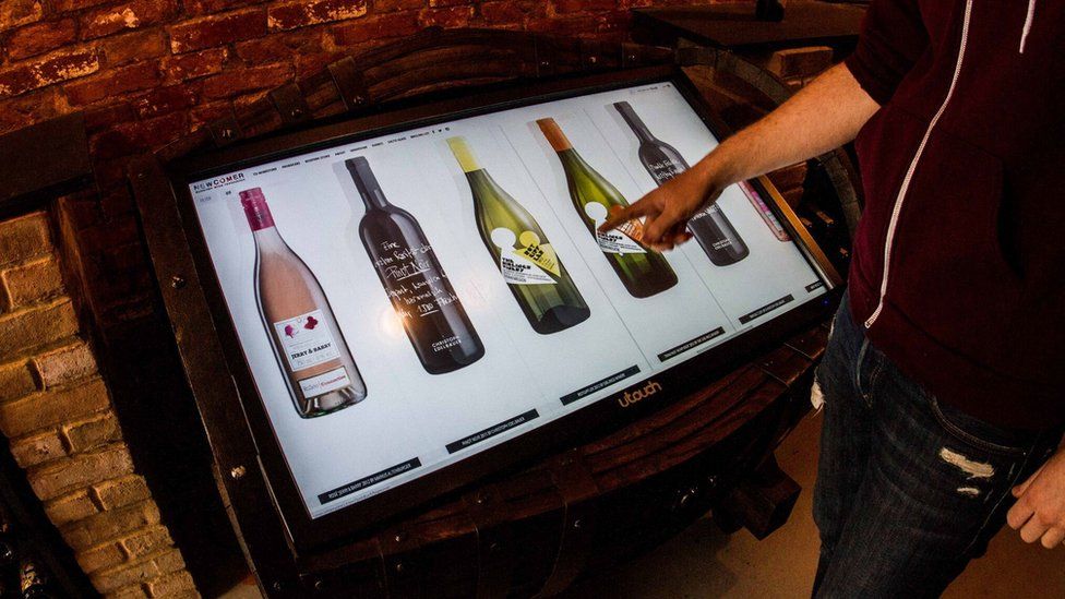 Digital display showing wine bottles