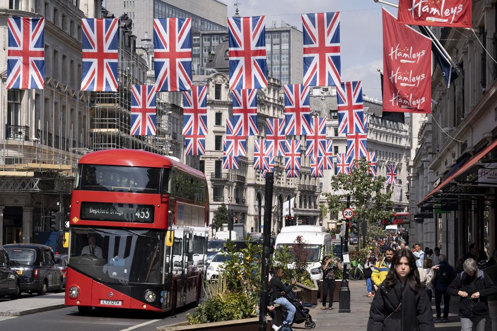 Union flags hang above shoppers on Regent Street.