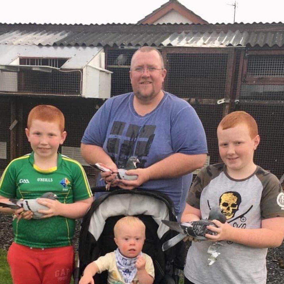 Alan Larkin and his sons Harry, Tom and Joseph hold some of their pigeons