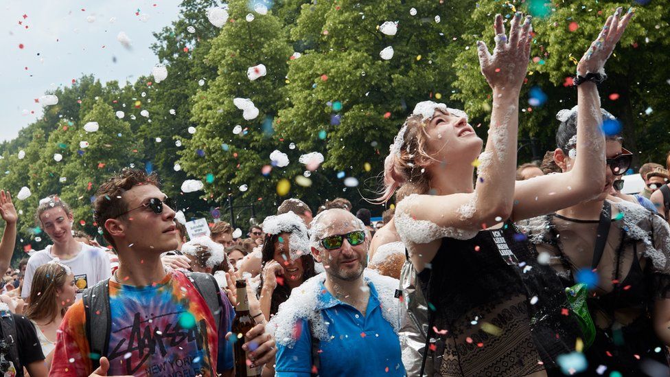 A woman throws confetti during a protest against a demonstration of the "Alternative for Germany" (AfD) party in Berlin, Germany, 27 May 2018.