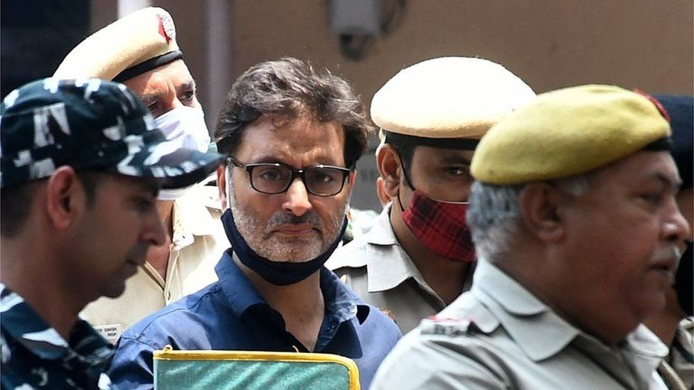 Yasin Malik, chairman of Jammu Kashmir Liberation Front (JKLF), a separatist party, is escorted by Indian police officers at a court premises in New Delhi, India, May 25, 2022.