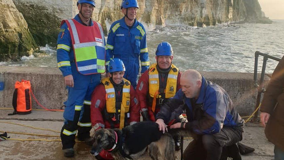 Dog, owner and coastguard rescue team