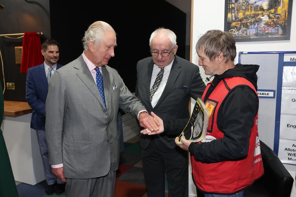 King Charles III, buys a copy of the Big Issue from seller Kelvin along with Lord John Bird the founder of the Big Issue at the launch of The Coronation Food Project in Didcot, Oxfordshire. November 14, 2023.