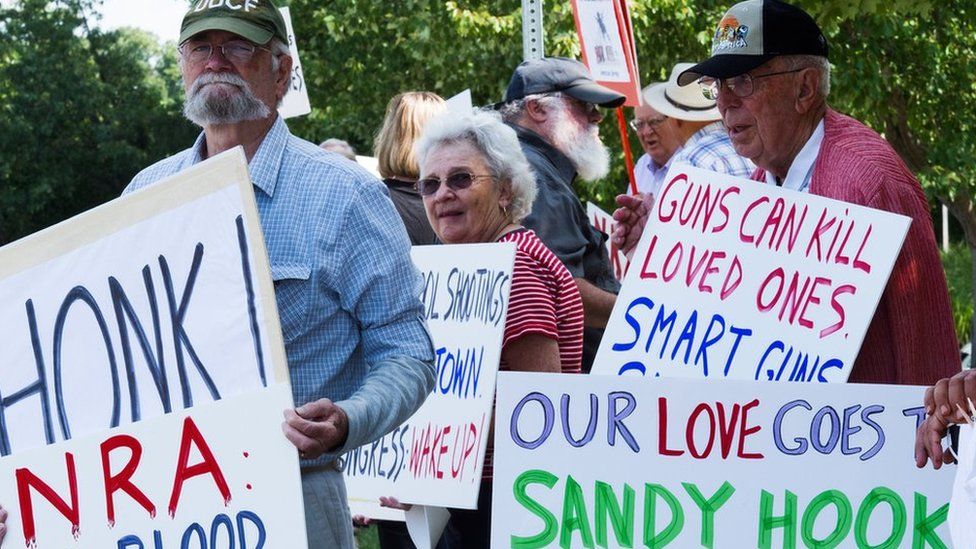 embers of the Coalition of Gun Violence Prevention gather for their monthly protest outside the National Rifle Association(NRA) headquarters August 14, 2014, in Fairfax, Virginia.