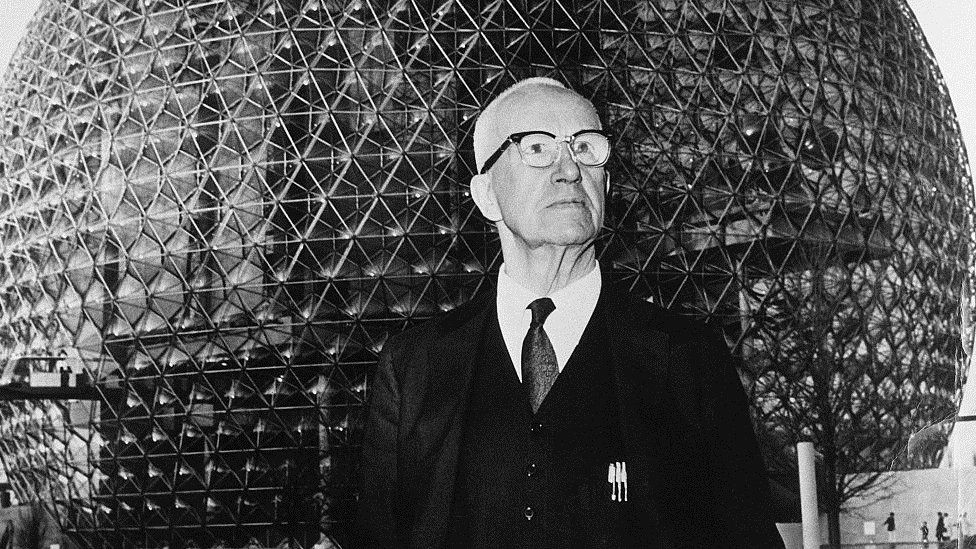Buckminster Fuller stands in front of his geodesic dome, the US pavilion at the 1967 World's Fair