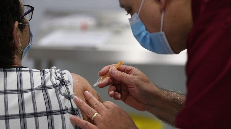 A person receives a coronavirus vaccine