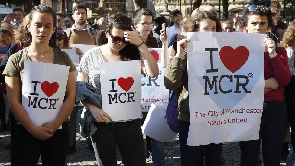 People gather ahead of a vigil in Albert Square, Manchester