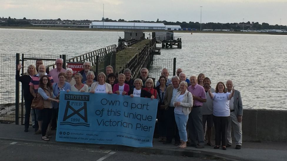 Campaigners celebrate by the pier
