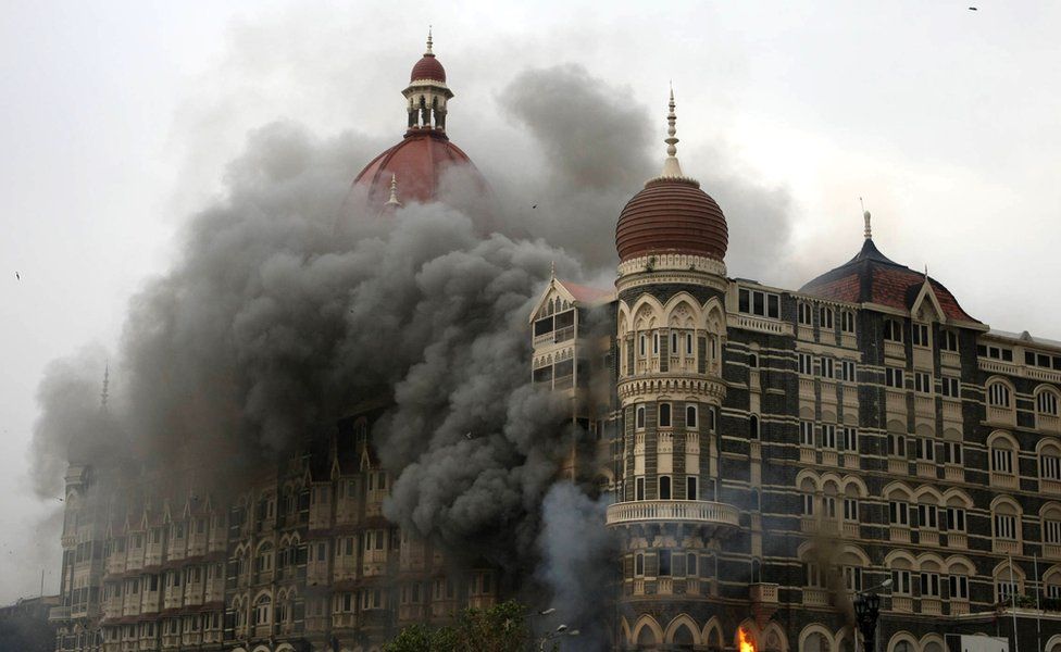 Smoke and flames billow out from The Taj Mahal hotel in Mumbai on November 29, 2008.