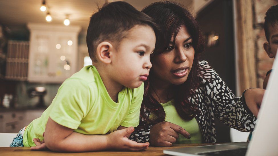 woman and child looking at the internet