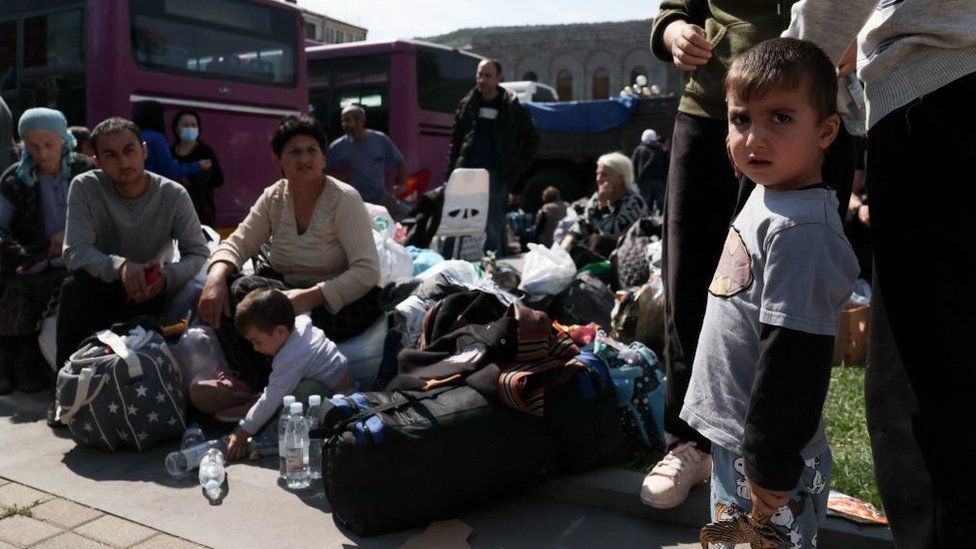 Armenian refugees wait in a square of Goris city centre on September 29, 2023