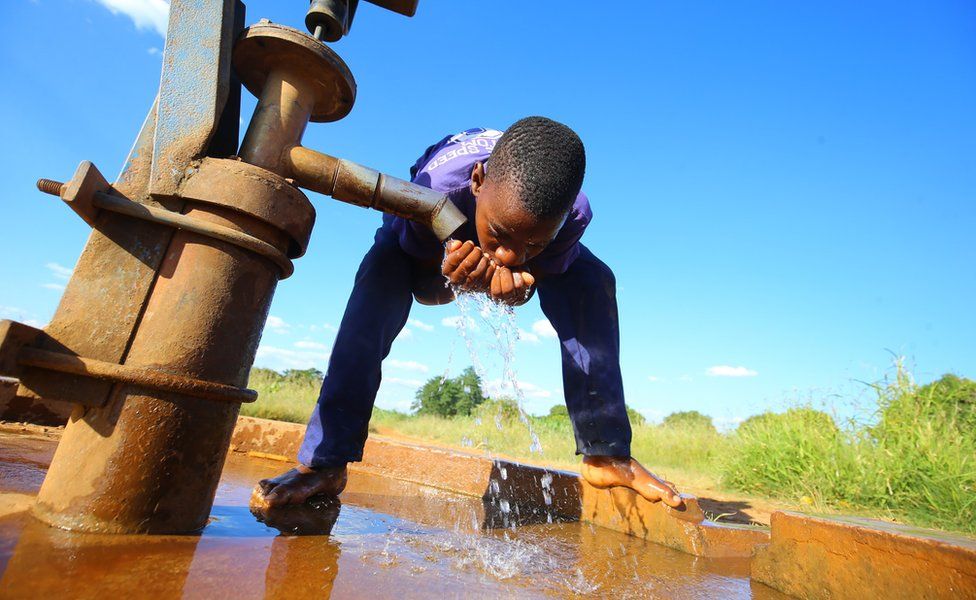 A boy drinks water from a public borehole in Chegutu, 100 km west of the capital, Harare, Zimbabwe, 22 January 2018.