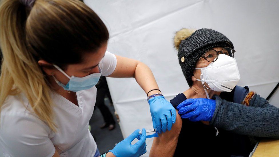 A file photo shows a healthcare worker administering a shot of the Moderna COVID-19 Vaccine to a woman at a pop-up vaccination site in New York in January 2021
