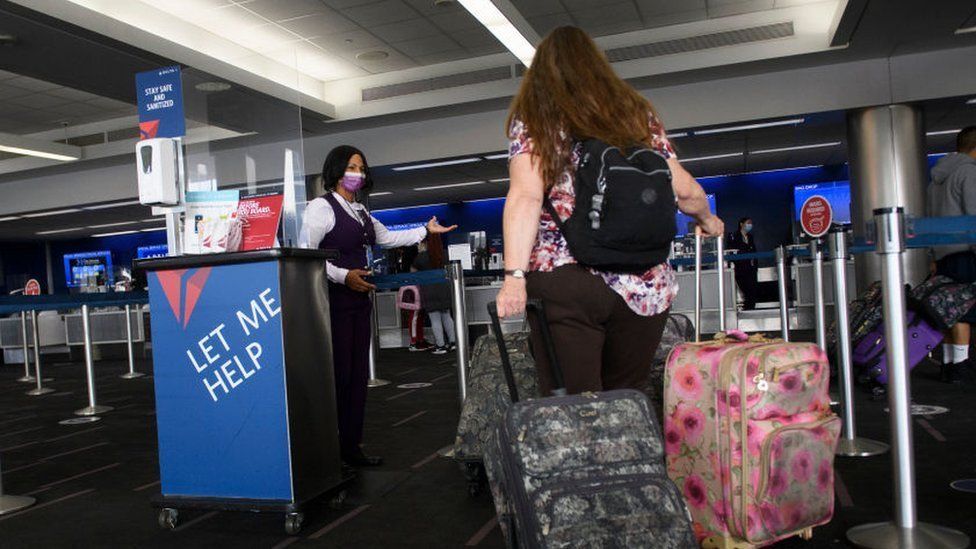 Woman checks in bags at Los Angeles International Airport