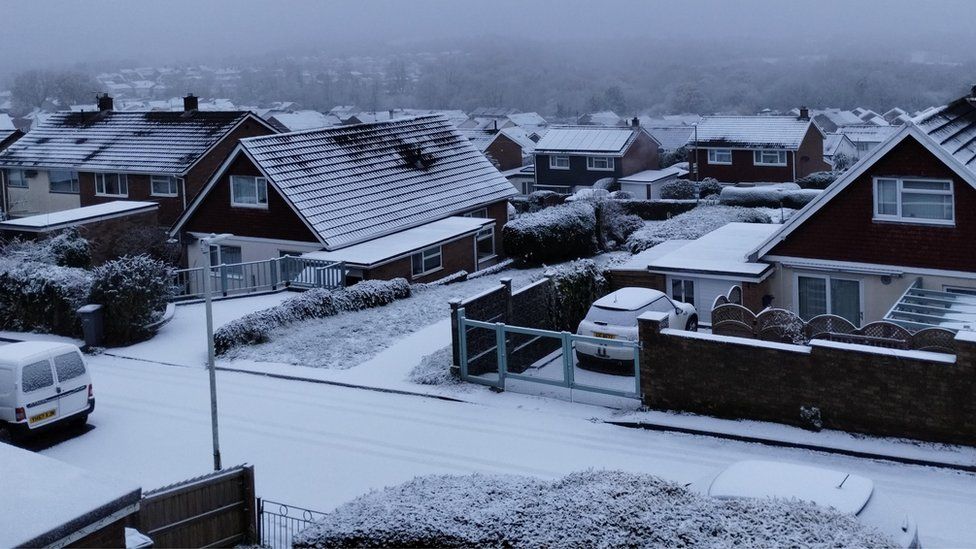 Snow covers roofs in New Inn, Torfaen