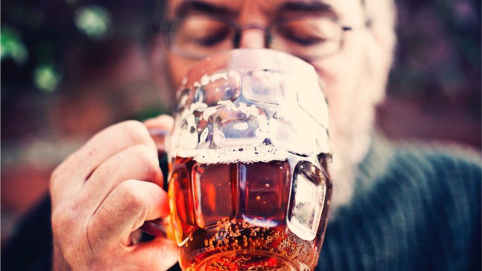 stock image of man drinking pint