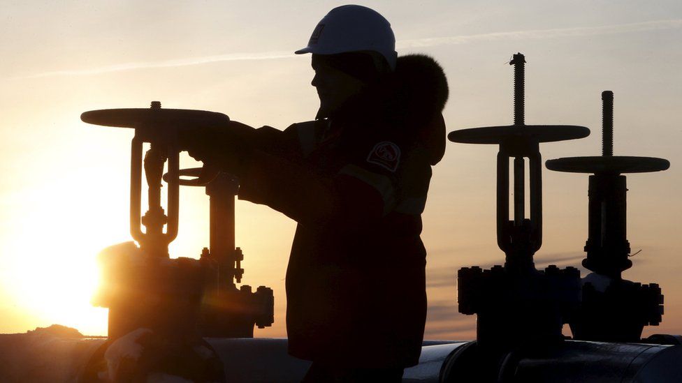 Man operates oil pipeline