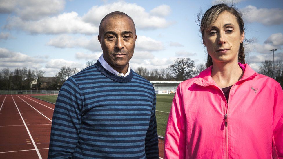 Colin Jackson and Rebecca Quinlan standing on an athletics track