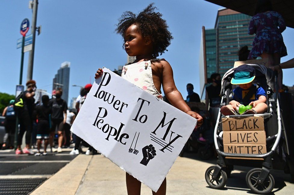 Families participate in a children's march in solidarity with the Black Lives Matter movement and national protests against police brutality on 9 June 2020 in the Brooklyn Borough of New York City