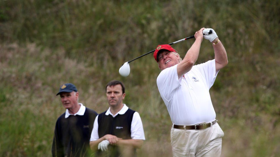 Donald Trump tees off from the third after the opening of The Trump International Golf Links Course