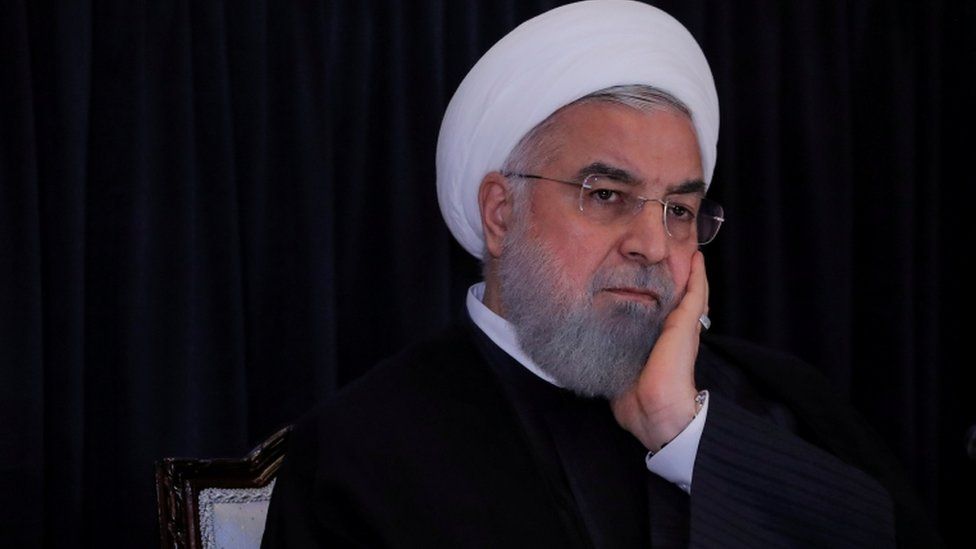Rouhani with head in hands