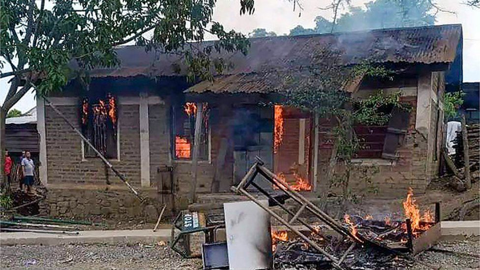 In this picture taken on May 3, 2023, smoke billows from a house allegedly burned by the Meitei community which is demanding inclusion under the Scheduled Tribes category, in Churachandpur district of India's Manipur state.