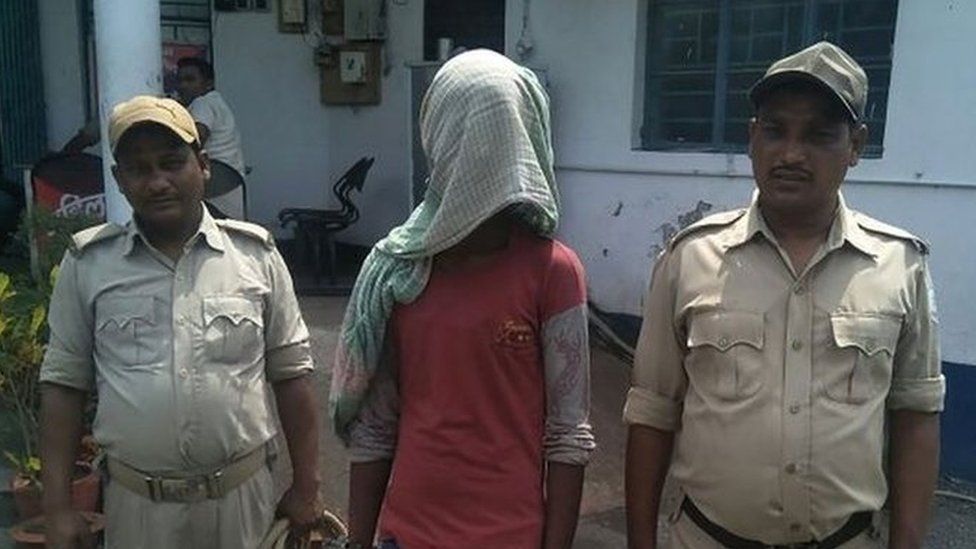 This photo taken on May 6, 2018 shows suspect being held by Indian police, in the case of a 17-year-old girl who police say was raped and set on fire in Pakur district, in India"s eastern Jharkhand state.
