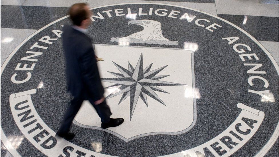 A man crosses the Central Intelligence Agency (CIA) seal in the lobby of CIA Headquarters in Langley, Virginia, on August 14, 2008
