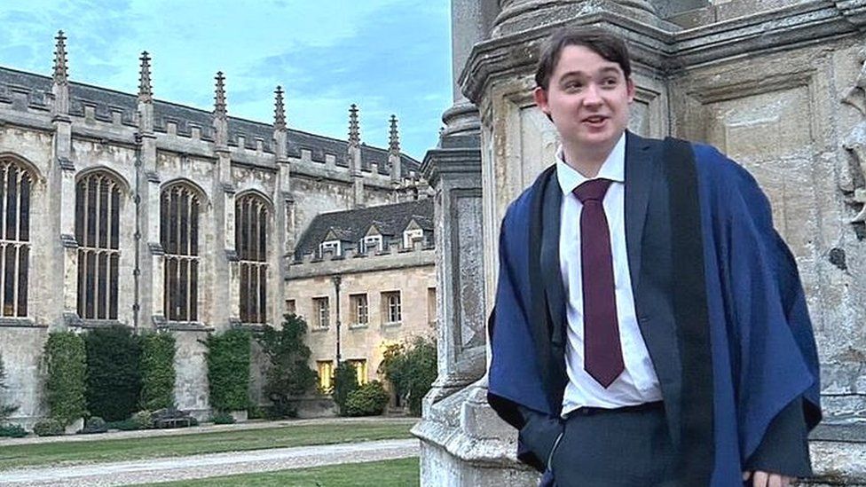 George in his University robes outside the University