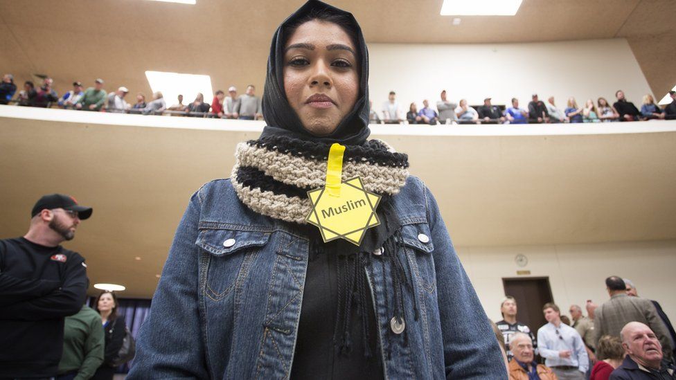 Rabya Ahmed listens as Republican presidential candidate Donald Trump makes a speech at a campaign rally on March 5, 2016 in Wichita, Kansas where the Republican party was staging one of its statewide caucus. She and other Muslim protesters were asked to leave the rally