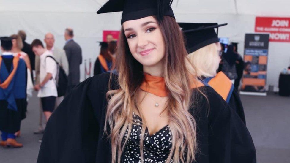 Chloe West wearing a cap and gown at her graduation
