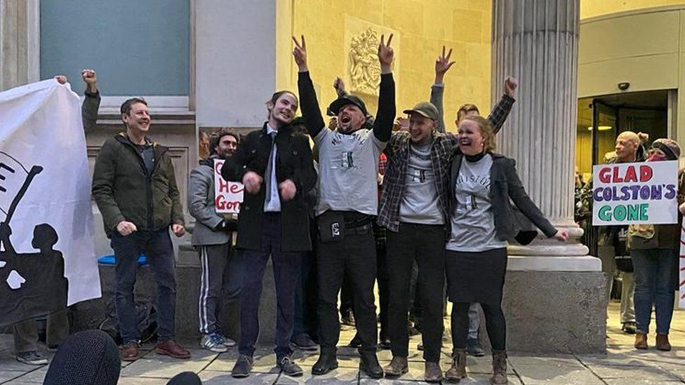 The four defendants celebrated outside the court after being found not guilty