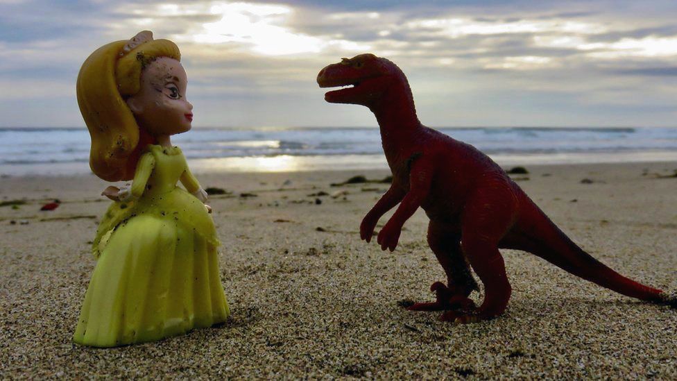 Doll and dinosaur