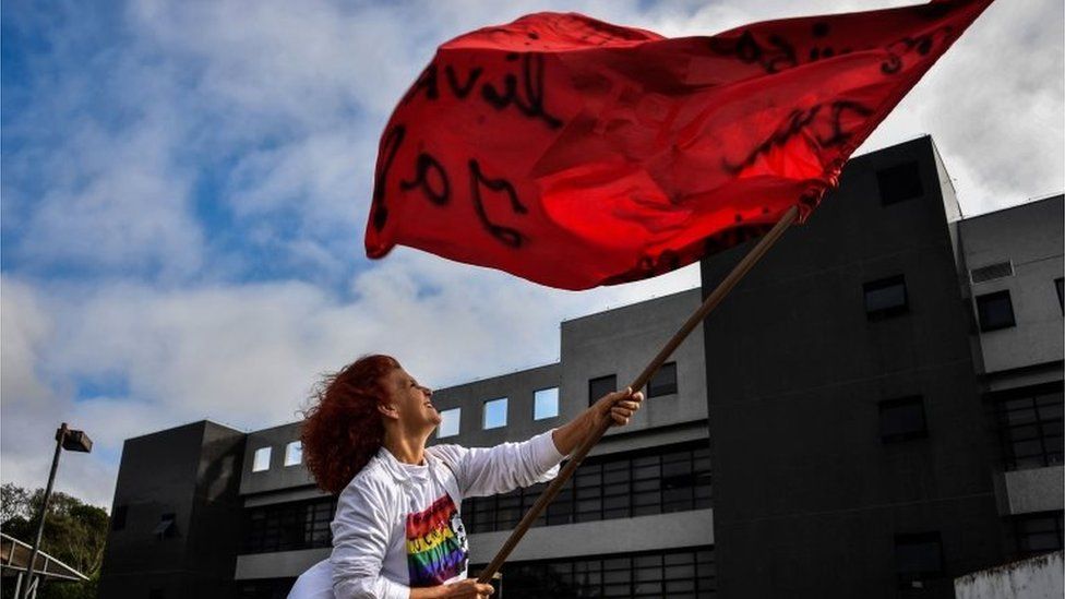 A supporter of Lula waves a Workers Part flag outside the jail in Curitiba
