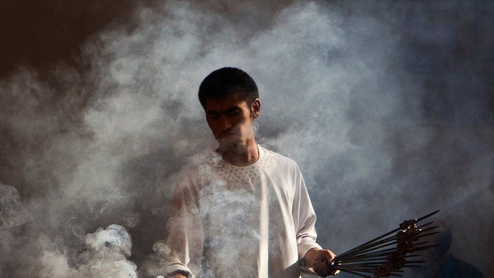 A man makes kebab at a restaurant in Kabul