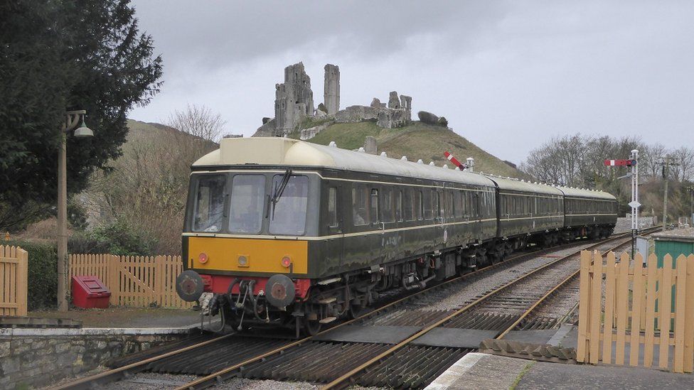 A diesel train at Corfe Castle station on the Swanage Steam Railway
