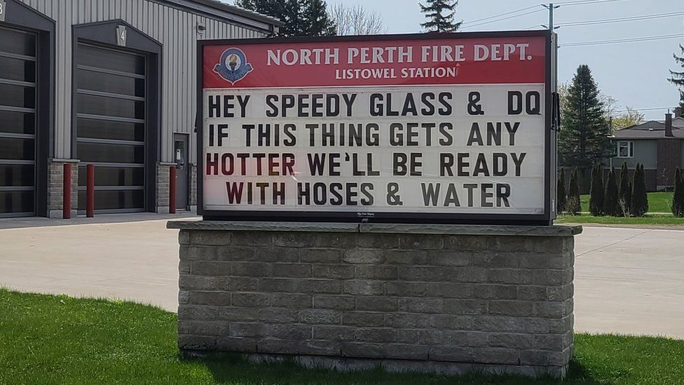 A sign from the fire department reads 'if this thing gets hotter, we'll be ready with hoses and water'