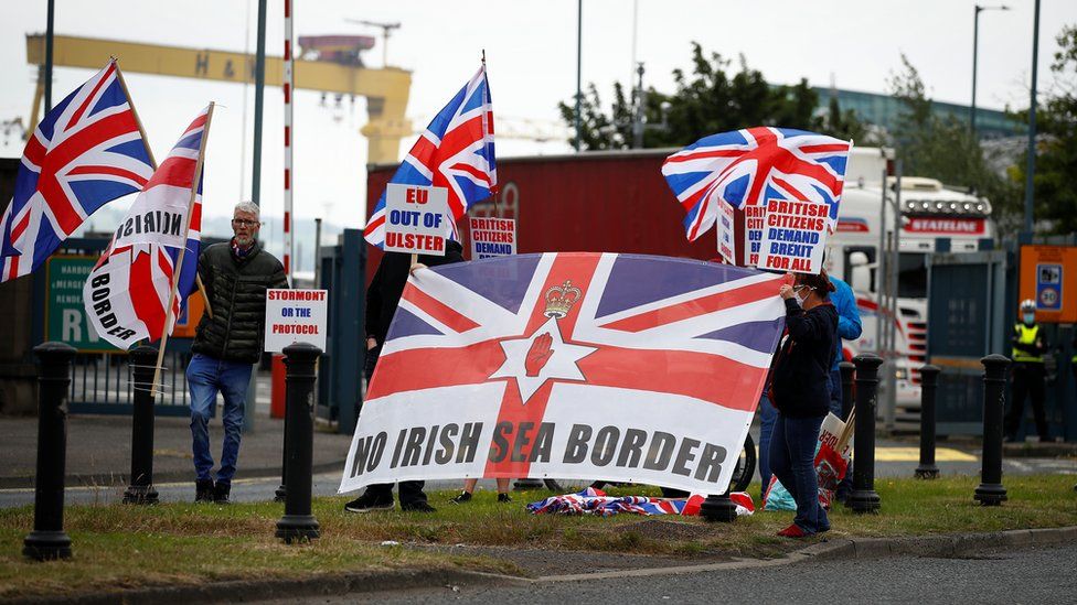 Unionists holding union flags and placards protest against the post-Brexit trade arrangements affecting Northern Ireland