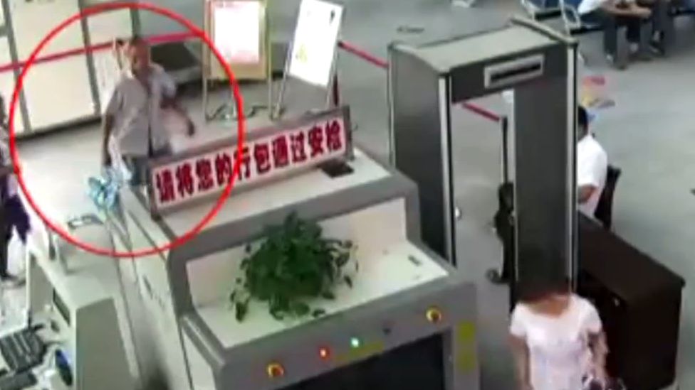 Mr Zheng seen on CCTV putting his bag through a security scanner
