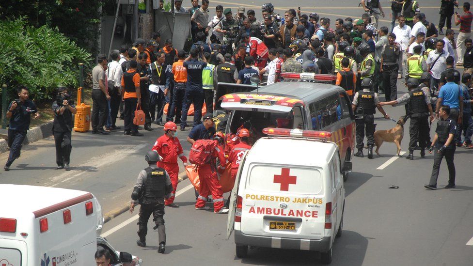 Police take the bodies of civilian victims of terrorist bomb explosion at the traffic police station to a hospital in Sarina, Jakarta on January 14, 2016