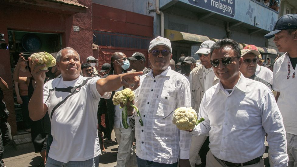 Former Madagascar president and member of the opposition Marc Ravalomanana (R) and opposition figure Roland Ratsiraka (L) hold cauliflowers during a march in Antananarivo, Madagascar - Saturday 7 October 2023