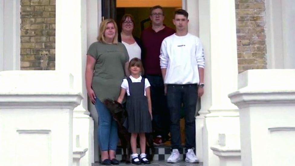 The family outside their home