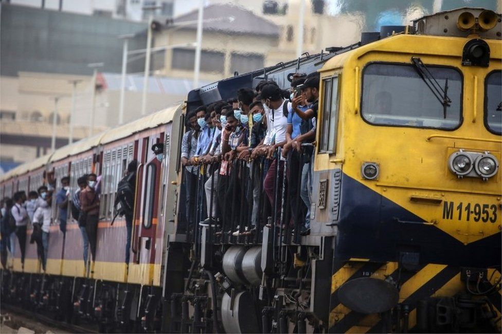 Passengers board an engine compartment of an overcrowded train amid a fuel shortage, in Colombo, Sri Lanka, 06 July 2022. The Sri Lankan government suspended nationwide fuel sales for private vehicles for two weeks due to the worsening fuel shortage in the country. The Indian Oceans Islands nation is facing its worst economic crisis in decades due to the lack of foreign exchange, resulting in severe shortages in food, fuel, medicine, and imported goods. EPA/CHAMILA KARUNARATHNE