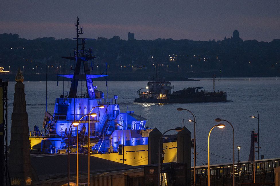 The Royal Navy's HMS Mersey is illuminated in the colours of Ukraine