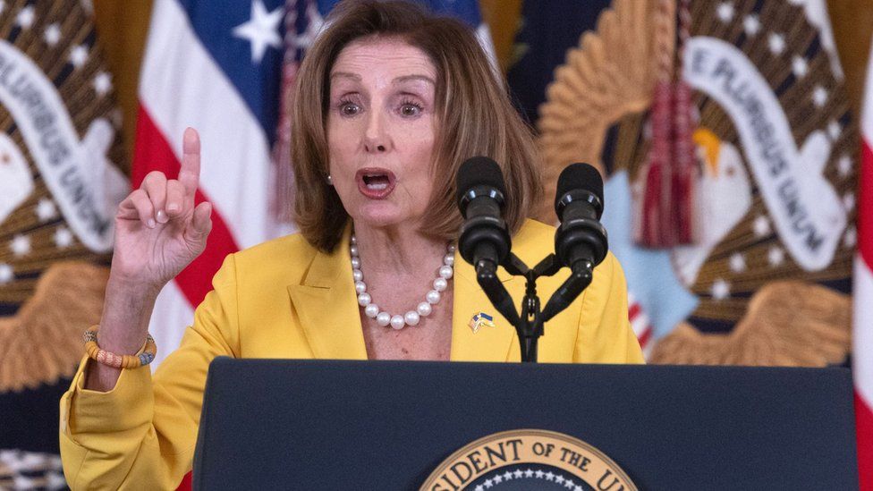 Nancy Pelosi speaking in front of supporters and lawmakers