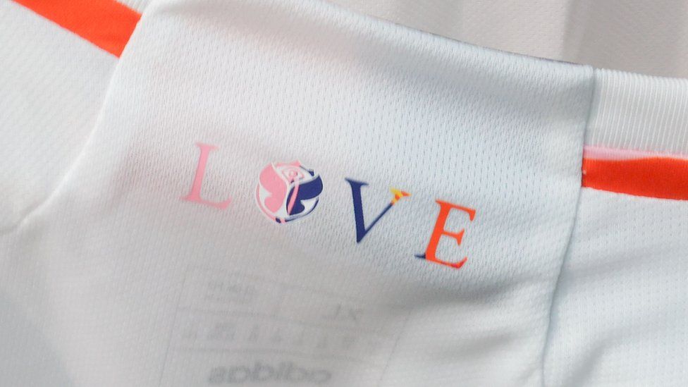 The word 'love' on the inside collar of Belgium's t-shirt