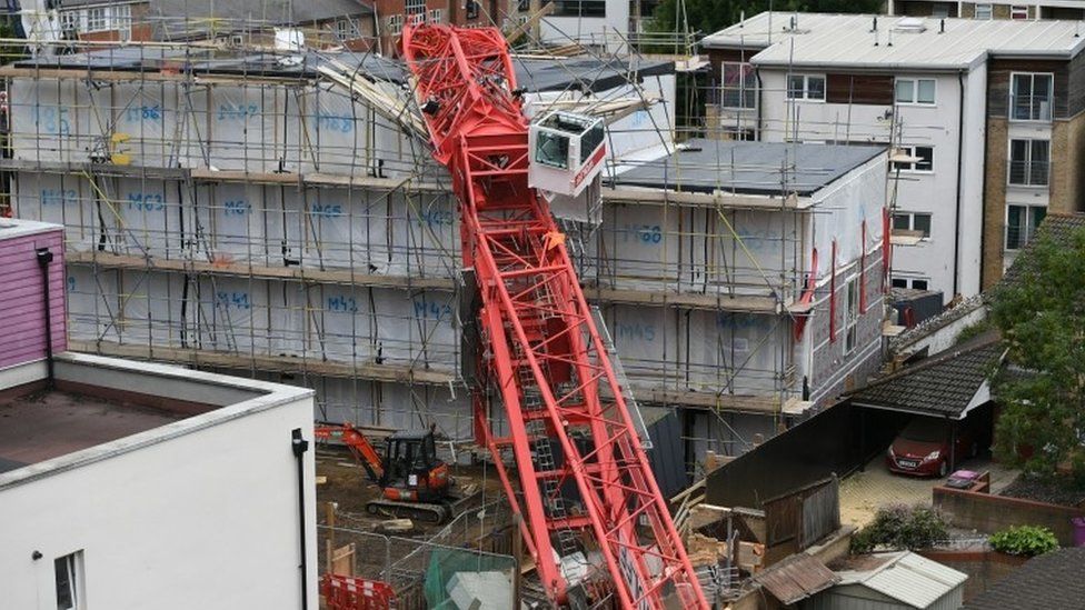 A crane crashed on to the development and two terrace houses in Compton Close, Bow