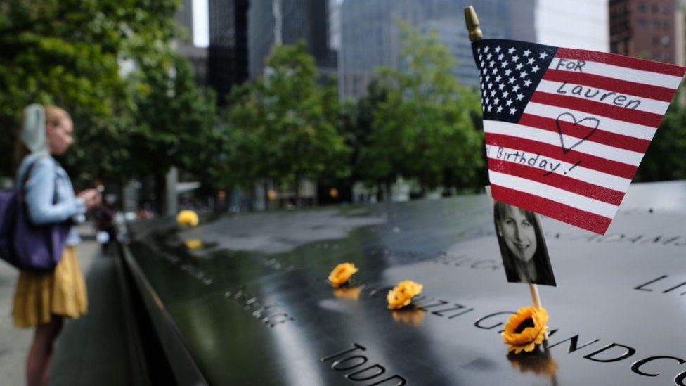 A US flag is placed near a victim's name at the September 11 Memorial at Ground Zero in New York