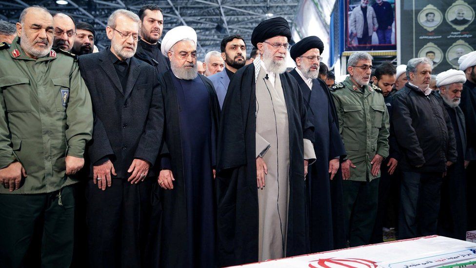 Iran's Supreme Leader, Ayatollah Ali Khamenei, and President Hassan Rouhani pray near the coffin of General Qasem Soleimani in Tehran (6 January 2020)